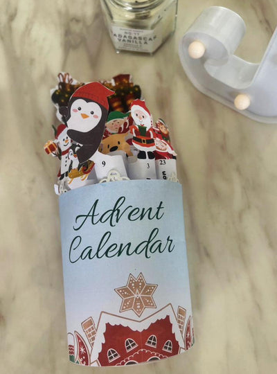 Advent calendar with Christmas-themed figures on a marble surface.